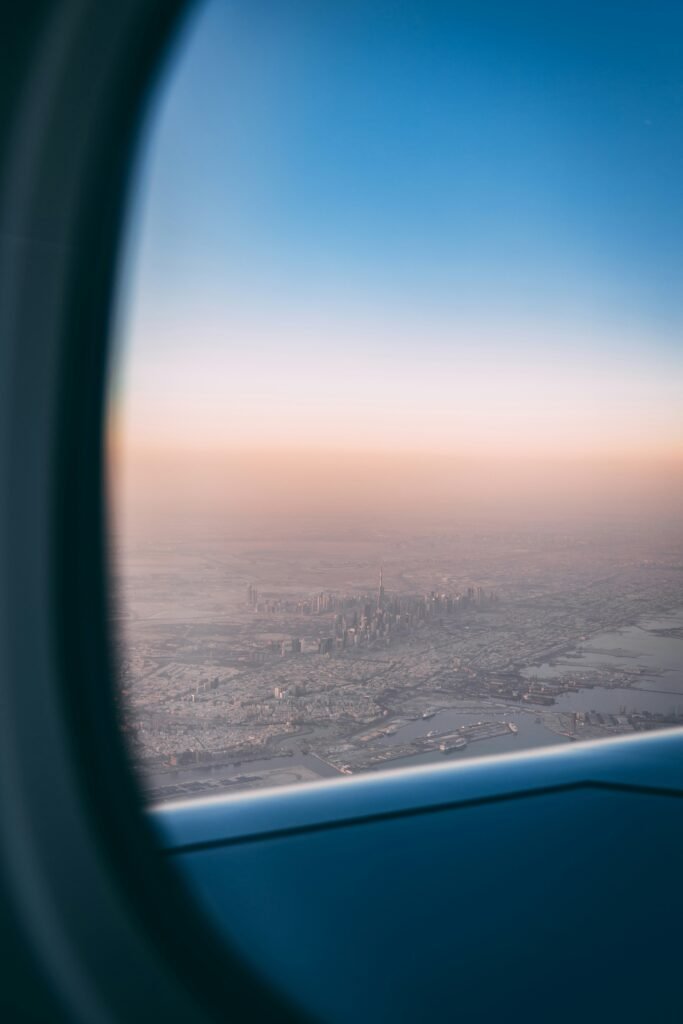 Dubai skyline seen from an airplane window during sunset, perfect inspiration for Free Stopover Flights in 2026