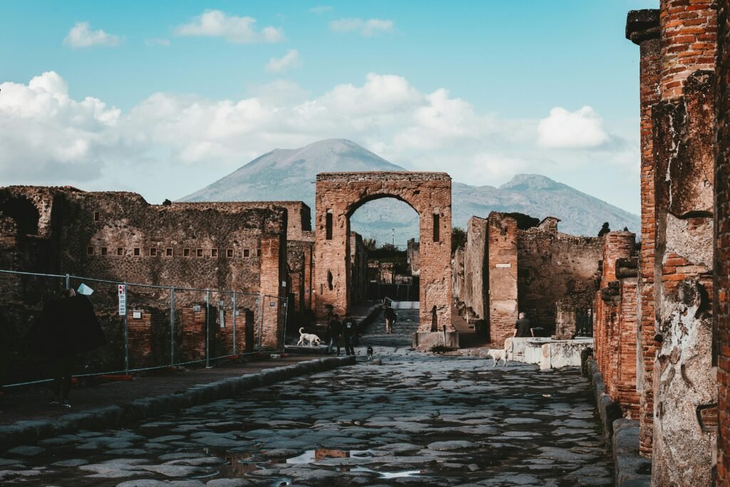 Pompeii ruins with Mount Vesuvius visible in the background on a clear day