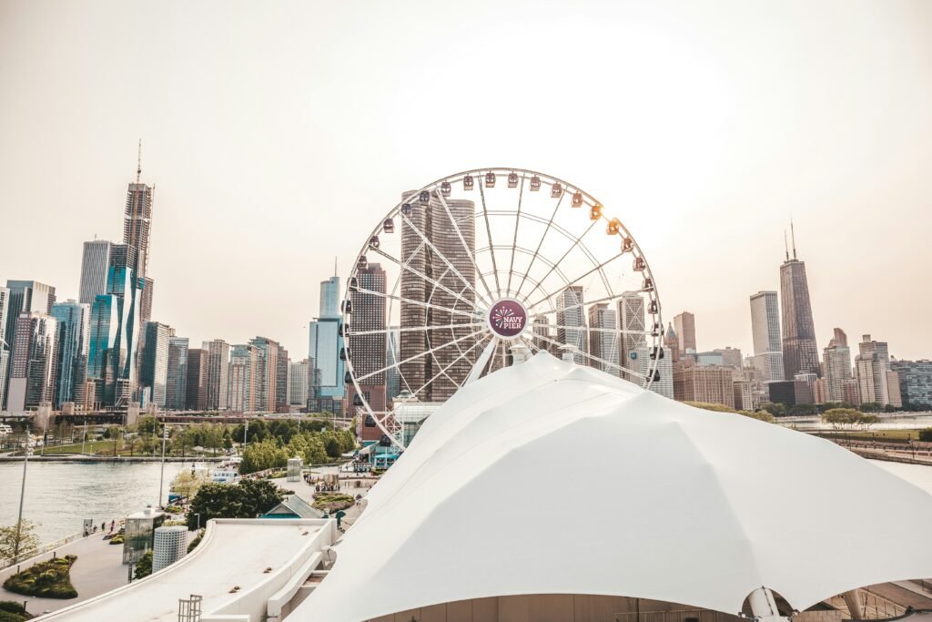 Navy Pier at sunset with the Ferris wheel lit up and the Chicago skyline behind it