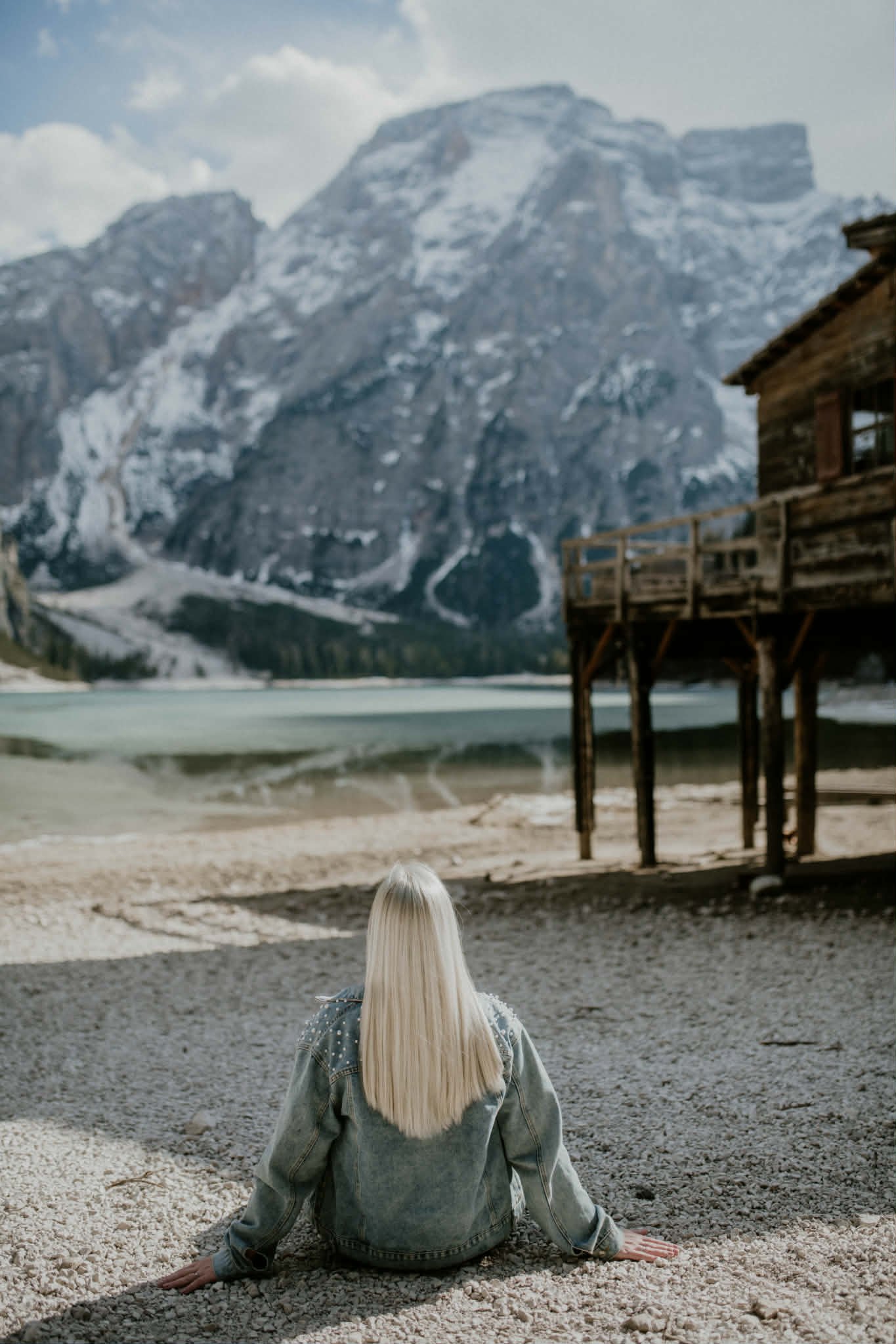 Lili sitting at Lago di Braies in the Dolomites