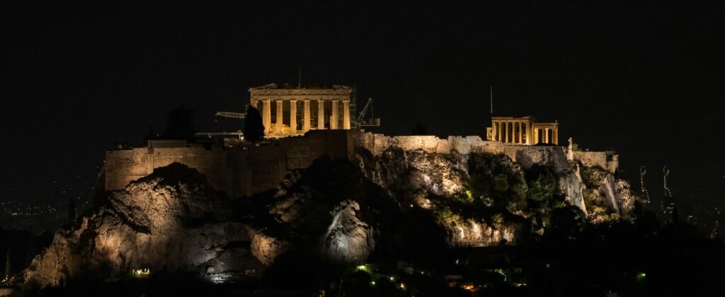 The illuminated Acropolis seen from an Athens rooftop bar at night