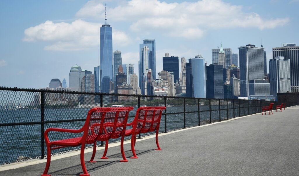 Red benches on the Brooklyn Heights Promenade overlooking the Lower Manhattan skyline