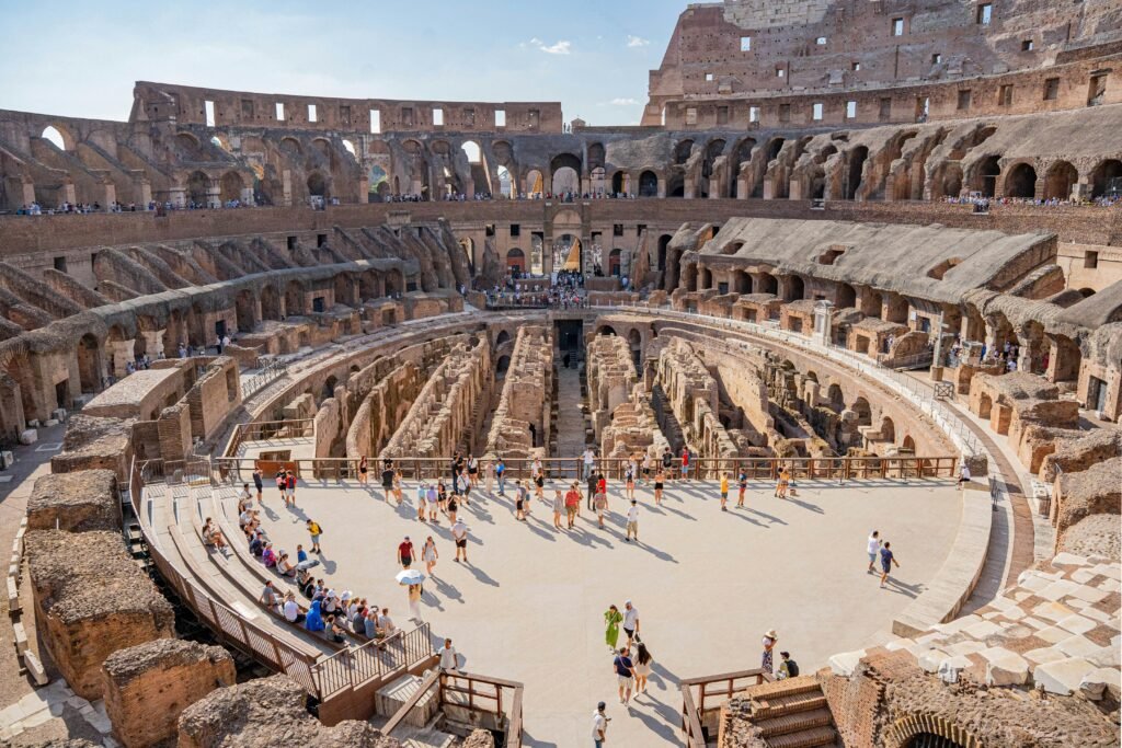 Inside the Colosseum in Rome with arena seating and stone arches