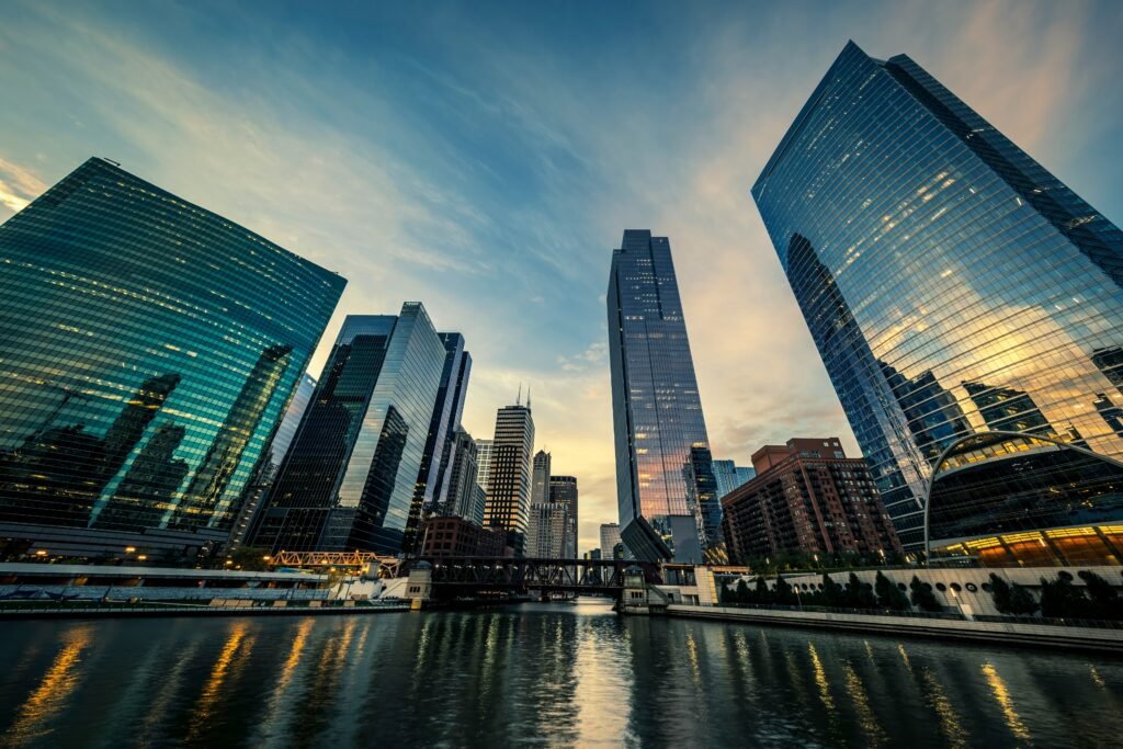 Chicago River skyline at sunset with glass towers reflected in the water