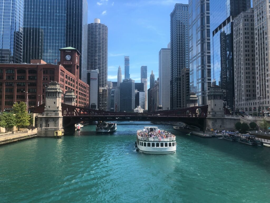 Architecture tour boat on the Chicago River surrounded by skyscrapers