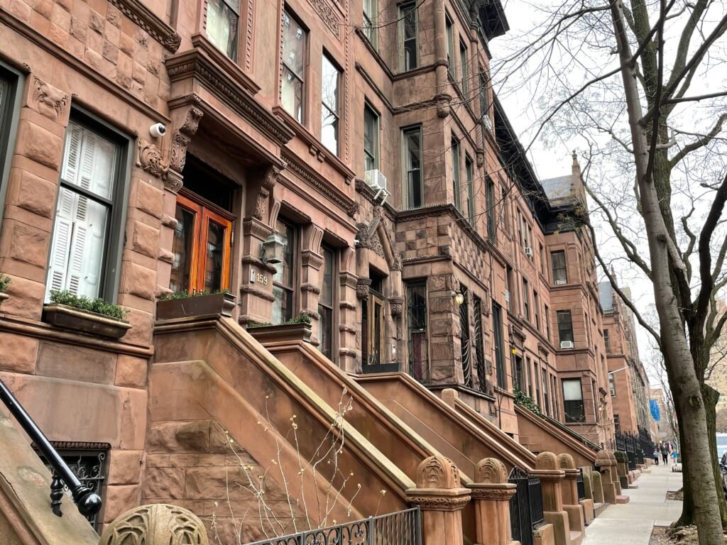 Brownstone townhouses on a tree-lined Upper West Side street in Manhattan