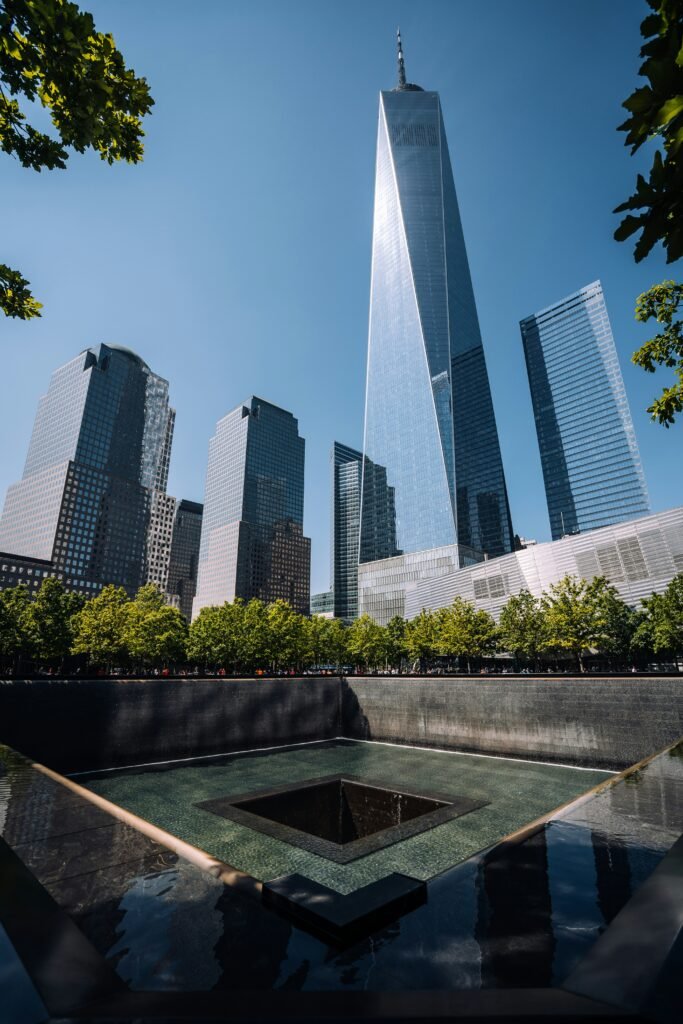 9/11 Memorial reflecting pool with One World Trade Center behind it