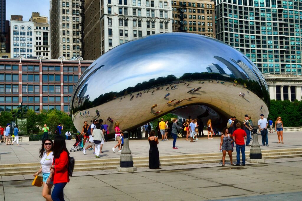 Cloud Gate in Millennium Park Chicago with visitors around the sculpture