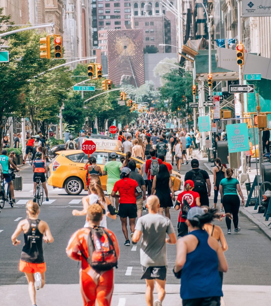 People enjoying a car-free New York City street during a summer open streets event