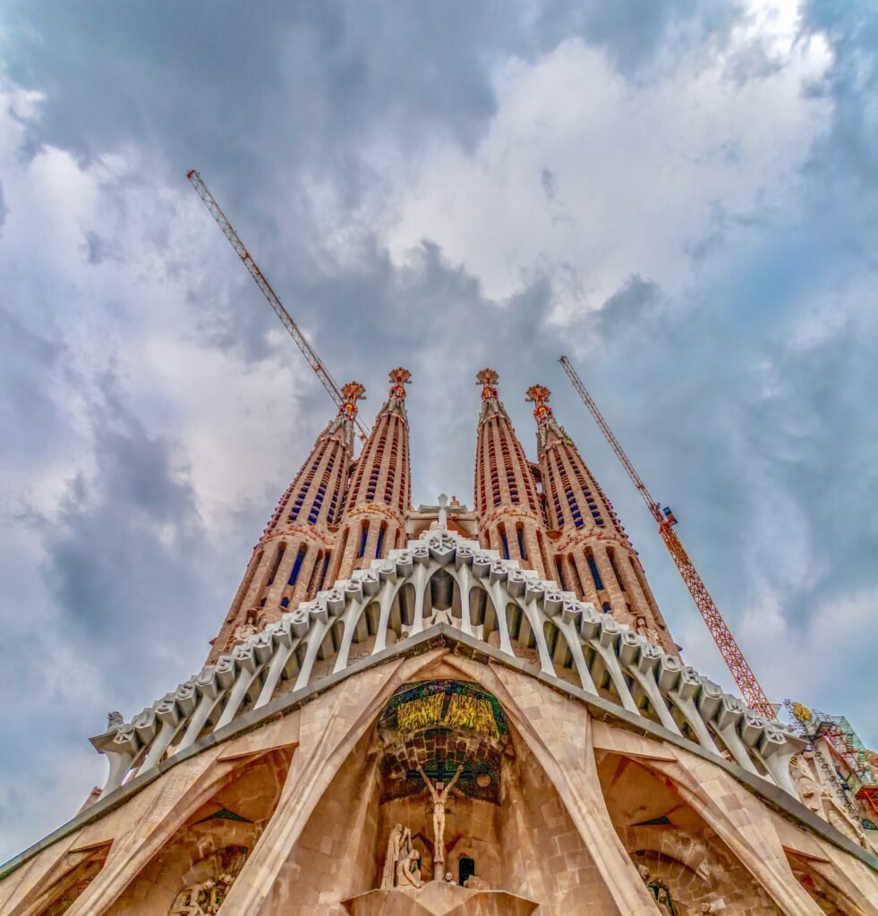 Sagrada Familia facade under dramatic clouds in Barcelona