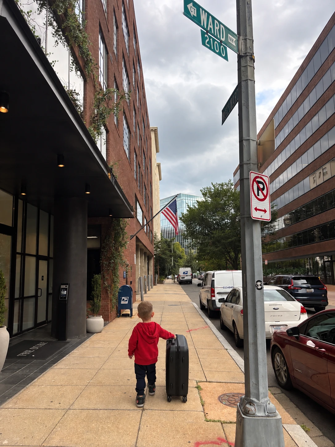 Lili's toddler pulling his own suitcase down a Washington, D.C. sidewalk near their hotel